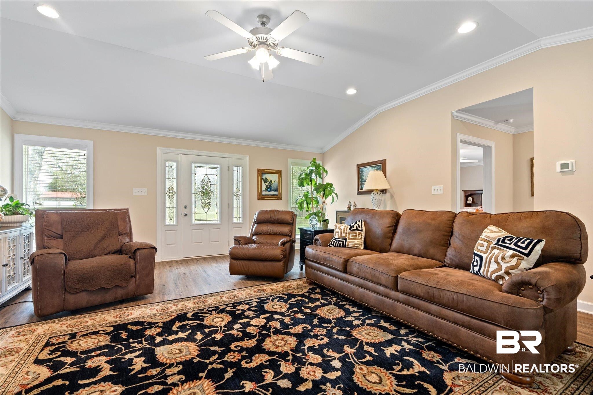 734 West Section Avenue Foley, AL 36535 - Photo 8 of 50 Living area with a ceiling fan, wood finished floors, recessed lighting, crown molding, and lofted ceiling