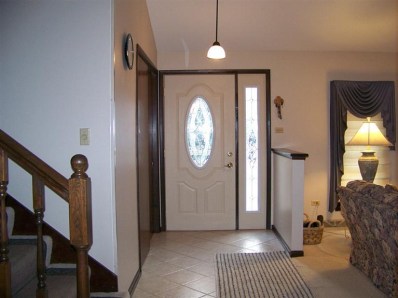 5046 89th Place Crown Point, IN 46307 - Photo 2 of 10 a view of a hallway with entryway wooden floor and front door