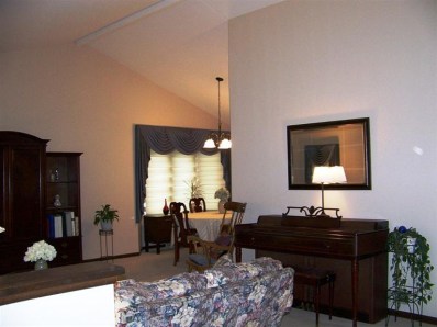 5046 89th Place Crown Point, IN 46307 - Photo 3 of 10 a living room with furniture a rug and a flat screen tv