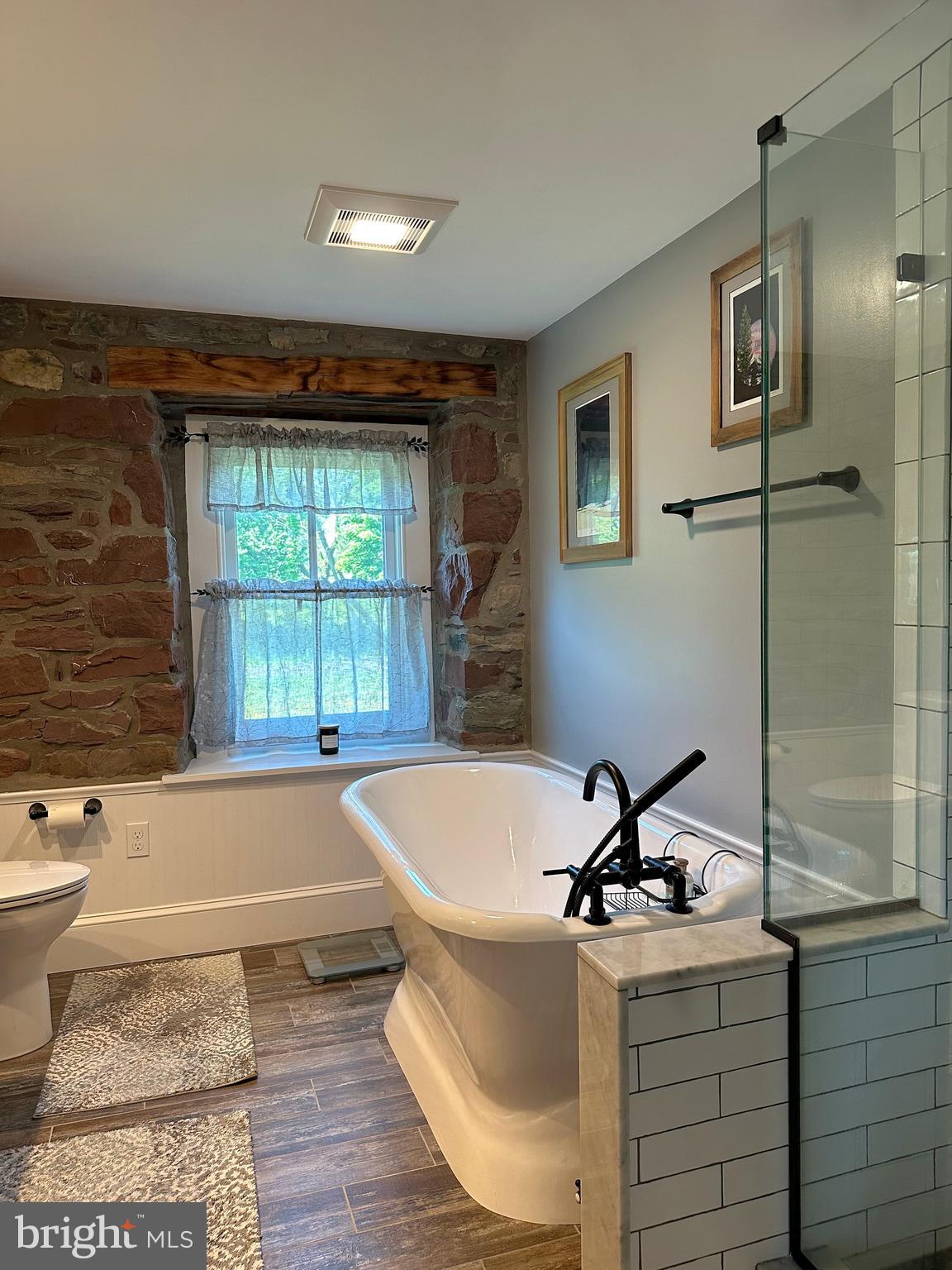 2382 Bergey Road Harleysville, PA 19438 - Photo 42 of 52 a white bath tub sitting in a bathroom next to a window