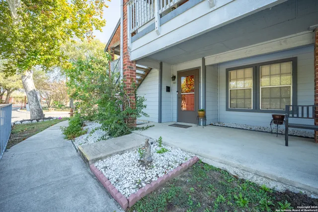 a view of a house with a bench in a garden