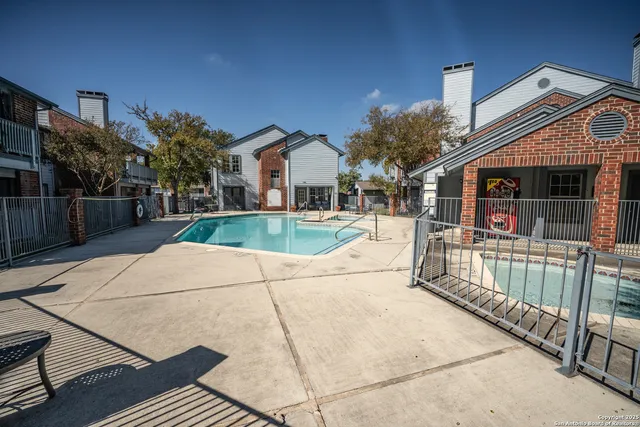 a view of a house with wooden fence
