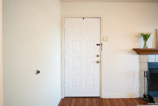 a view of a hallway with wooden floor and closet