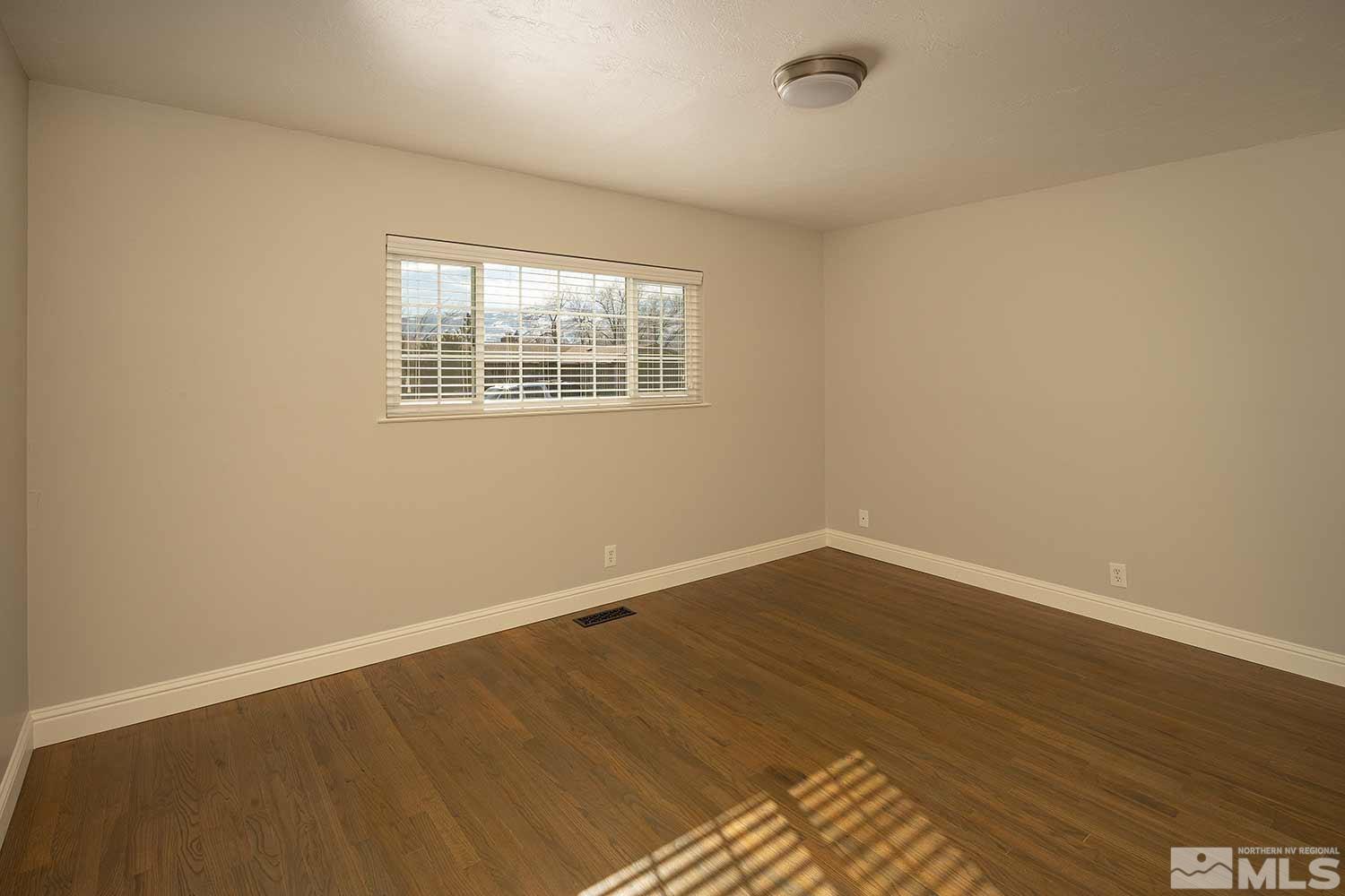 1465 West 12th Street Reno, NV 89503 - Photo 24 of 40 an empty room with wooden floor and windows