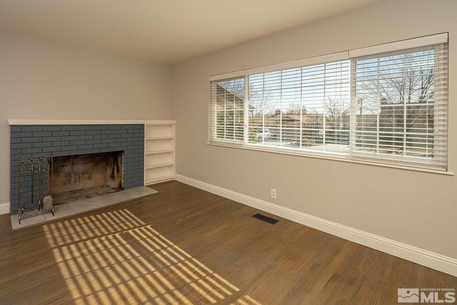 1465 West 12th Street Reno, NV 89503 - Photo 8 of 40 a view of an empty room with wooden floor and a window