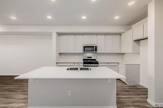a kitchen with white cabinets and white appliances