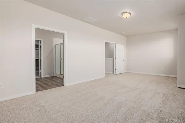 a view of an empty room and closet