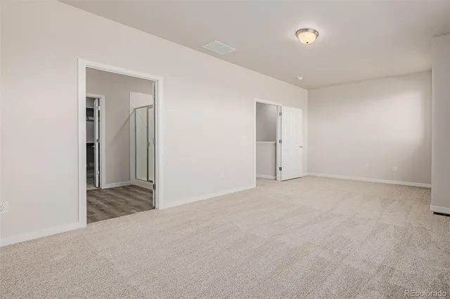 a view of an empty room and closet