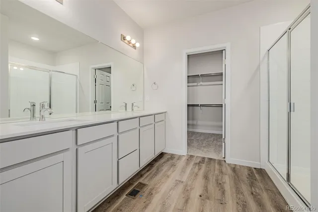 a spacious bathroom with a double vanity sink and a mirror