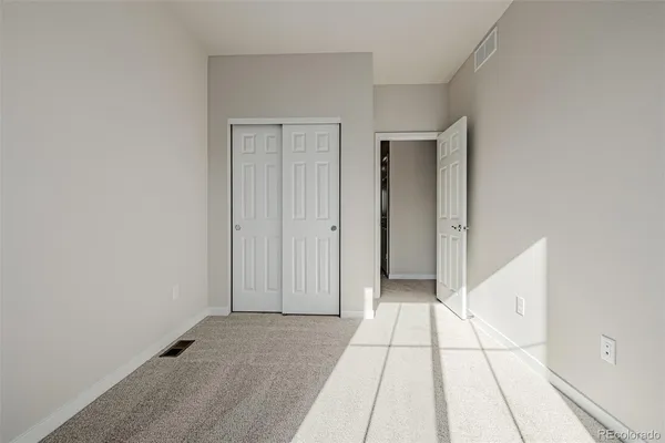 a view of a livingroom with an empty space and a hallway