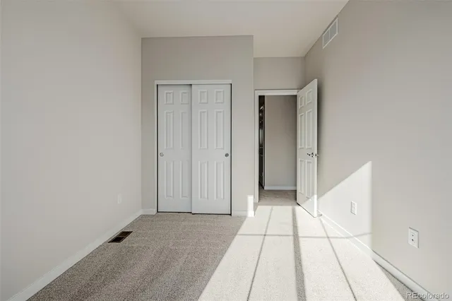 a view of a livingroom with an empty space and a hallway