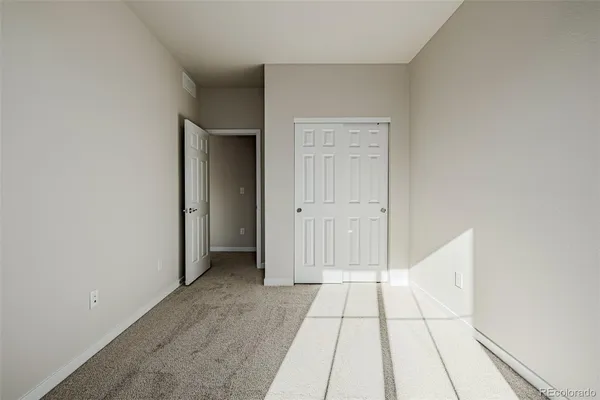 wooden floor in a hall with an empty room