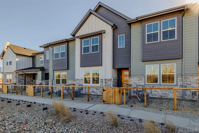 a backyard of a house with barbeque oven table and chairs