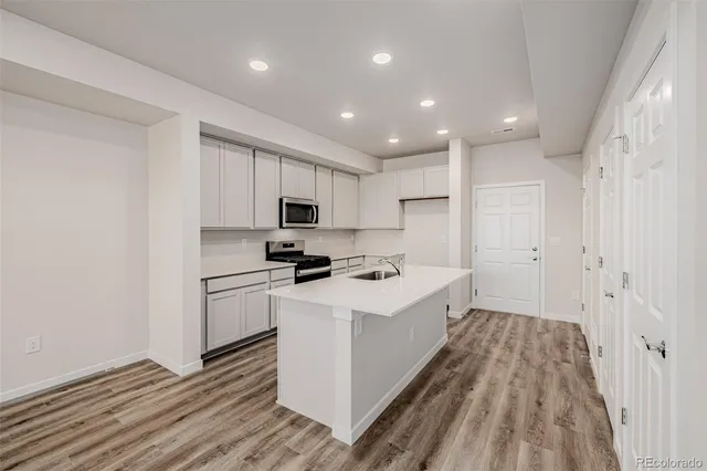 a kitchen with white cabinets and white appliances