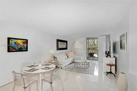 a living room with furniture a rug and a flat screen tv