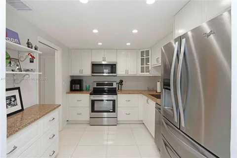 a kitchen with stainless steel appliances a refrigerator stove and sink