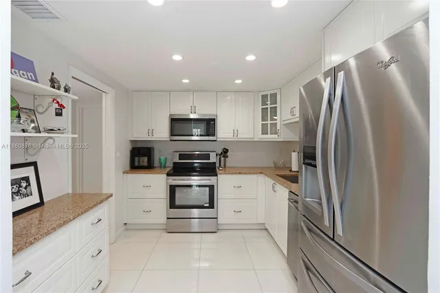 a kitchen with stainless steel appliances a refrigerator stove and sink