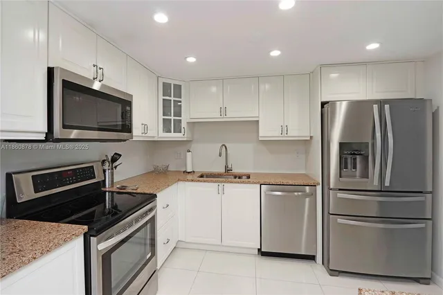 a kitchen with stainless steel appliances granite countertop a stove microwave and refrigerator