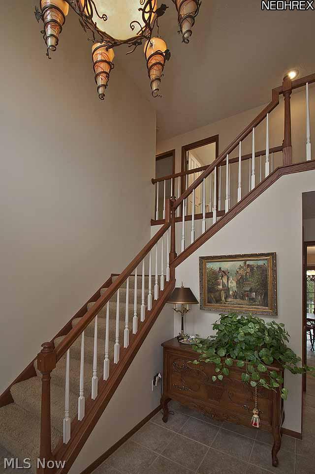 357 Longspur Road Highland Heights, OH 44143 - Photo 10 of 22 Large and Inviting2 Story Foyer features an Original Custom-made Light Fixture and new European style Pella wood steel-fiberglass front door with leaded glass sidelights and huge Palladian window