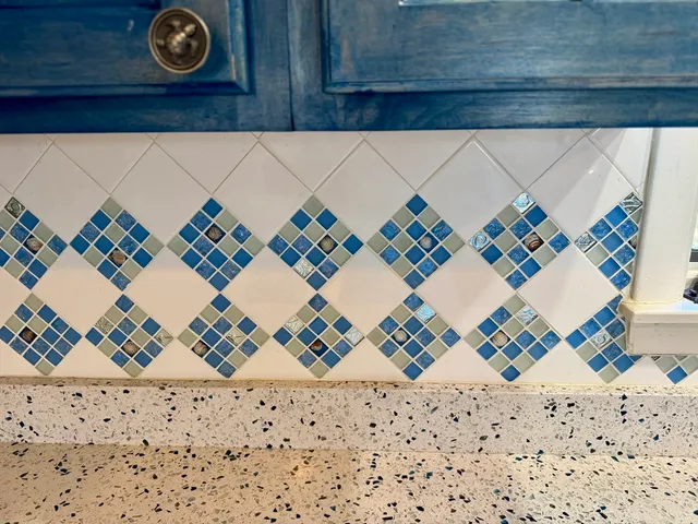 a white building with a black gate