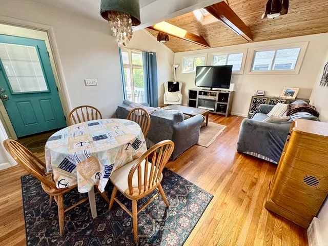 a living room with furniture a flat screen tv and a table