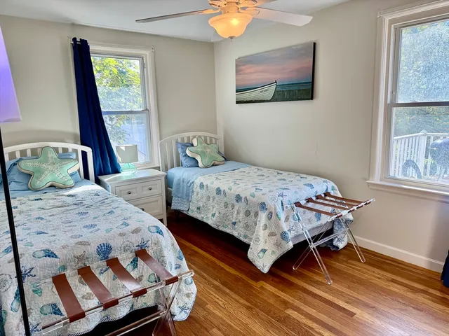 a bedroom with two beds and a window