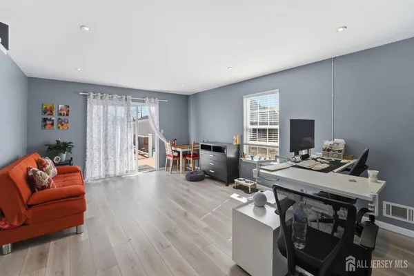 a view of a livingroom with furniture and a flat screen tv