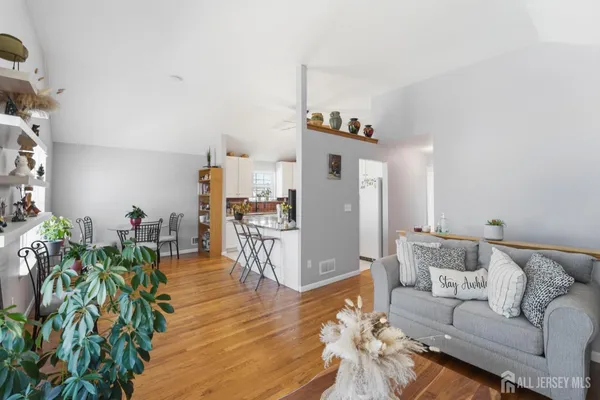a living room with furniture and a wooden floor