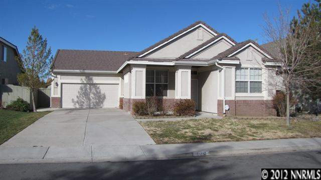 10261 Wolf Ridge Way Reno, NV 89521 - Photo 1 of 1 a front view of a house with a yard and garage