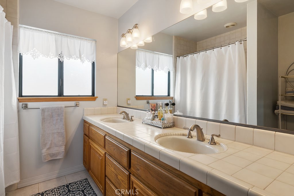 772 East Northridge Avenue Glendora, CA 91741 - Photo 24 of 35 a bathroom with a double vanity sink and a mirror