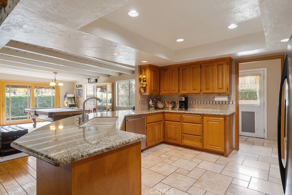 772 East Northridge Avenue Glendora, CA 91741 - Photo 9 of 35 a kitchen with stainless steel appliances granite countertop a sink and dishwasher with a dining table
