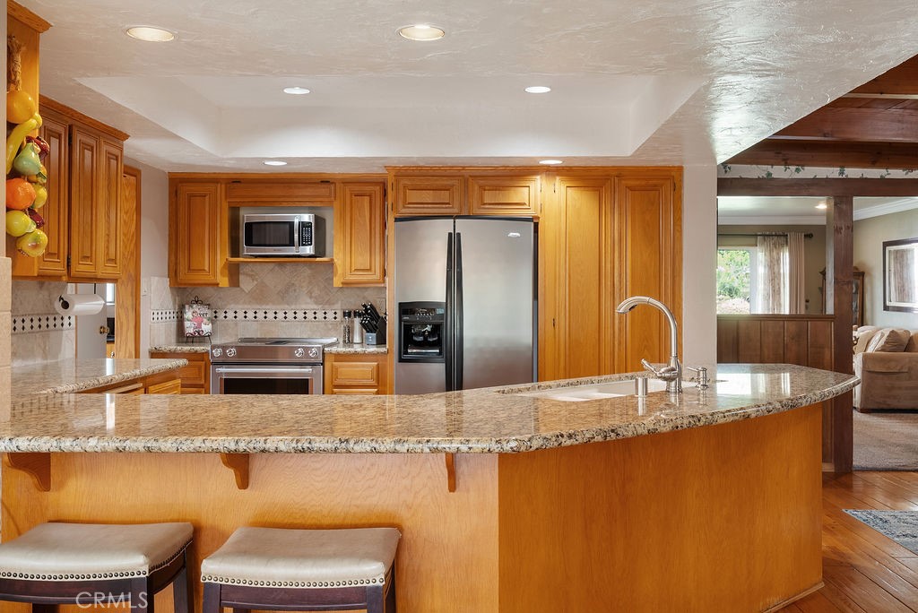 772 East Northridge Avenue Glendora, CA 91741 - Photo 10 of 35 a kitchen with stainless steel appliances granite countertop a sink and a refrigerator