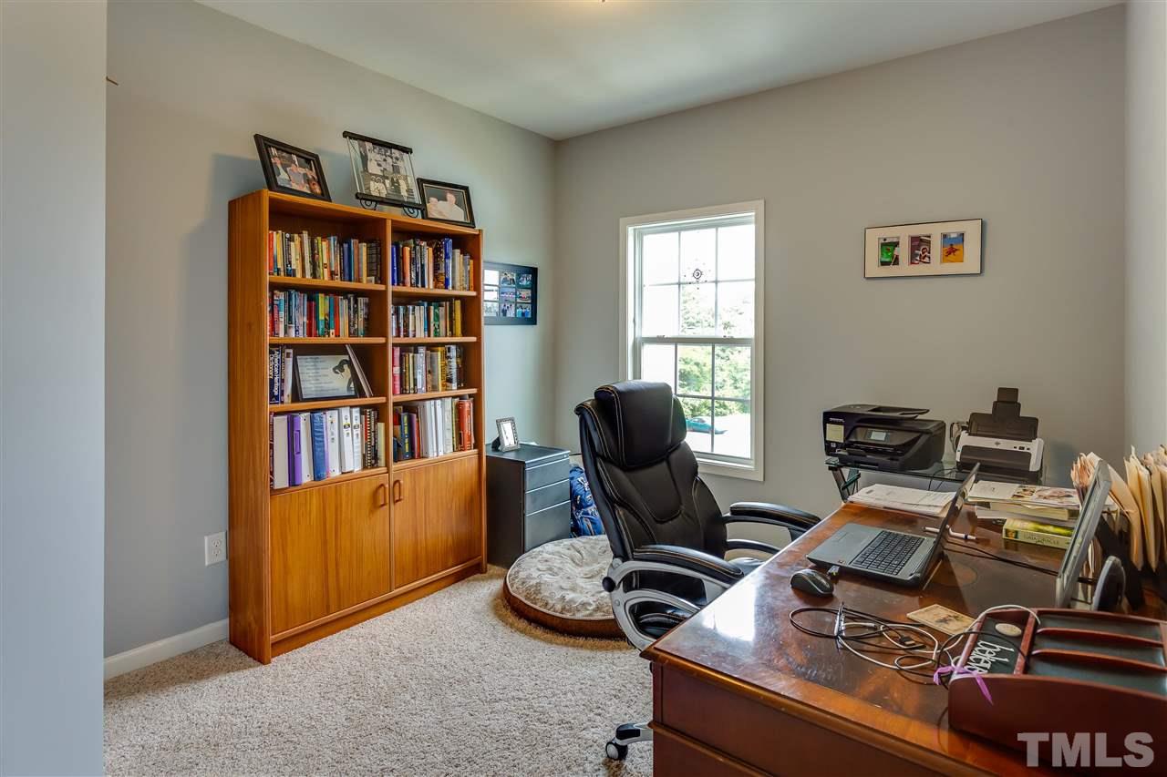 1309 Rembrandt Circle Raleigh, NC 27607 - Photo 22 of 24 a view of a workspace with furniture and a bookshelf