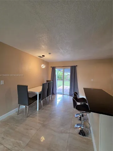 a dining room with a table and chairs