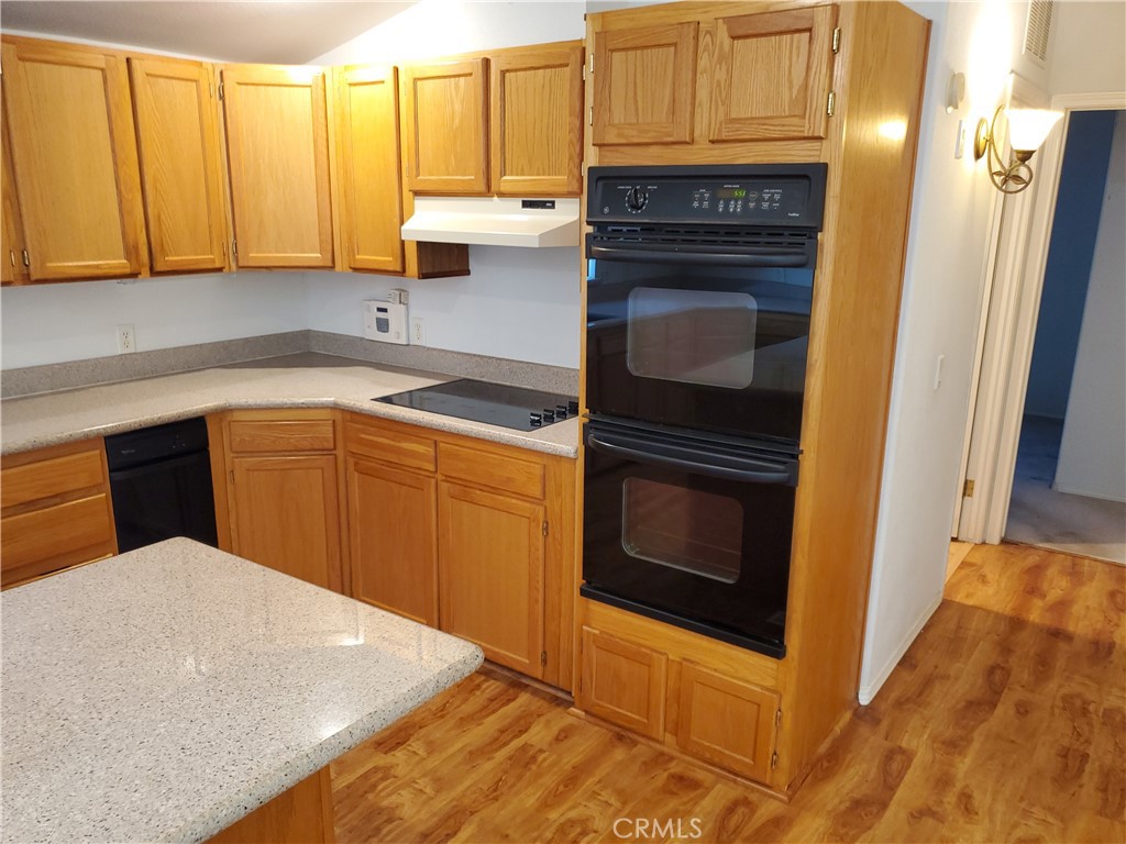 76 Orchardcrest Drive Oroville, CA 95965 - Photo 12 of 24 a kitchen with granite countertop cabinets stainless steel appliances and a sink