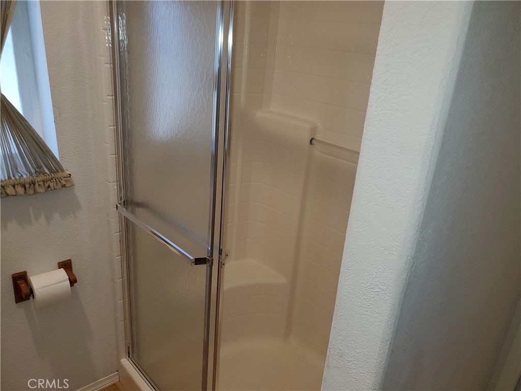 76 Orchardcrest Drive Oroville, CA 95965 - Photo 15 of 24 a bathroom with a glass door shower
