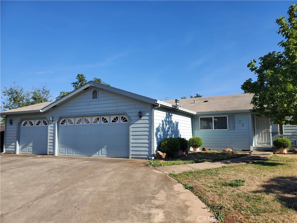 76 Orchardcrest Drive Oroville, CA 95965 - Photo 2 of 24 a front view of a house with a yard and garage