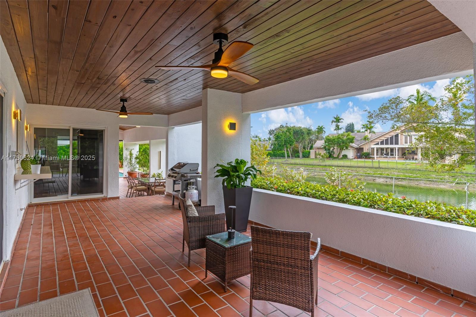 9260 Southwest 101st Street Miami, FL 33176 - Photo 53 of 67 a view of a patio with table and chairs and potted plants