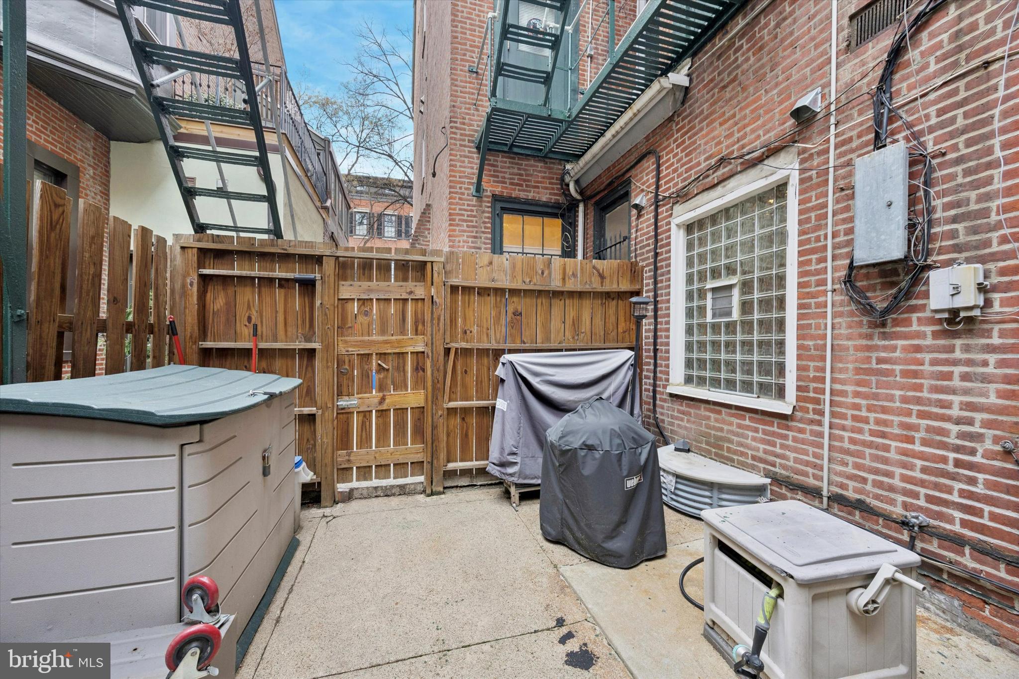 916 Clinton Street Philadelphia, PA 19107 - Photo 12 of 13 a view of a patio with table and chairs and wooden fence