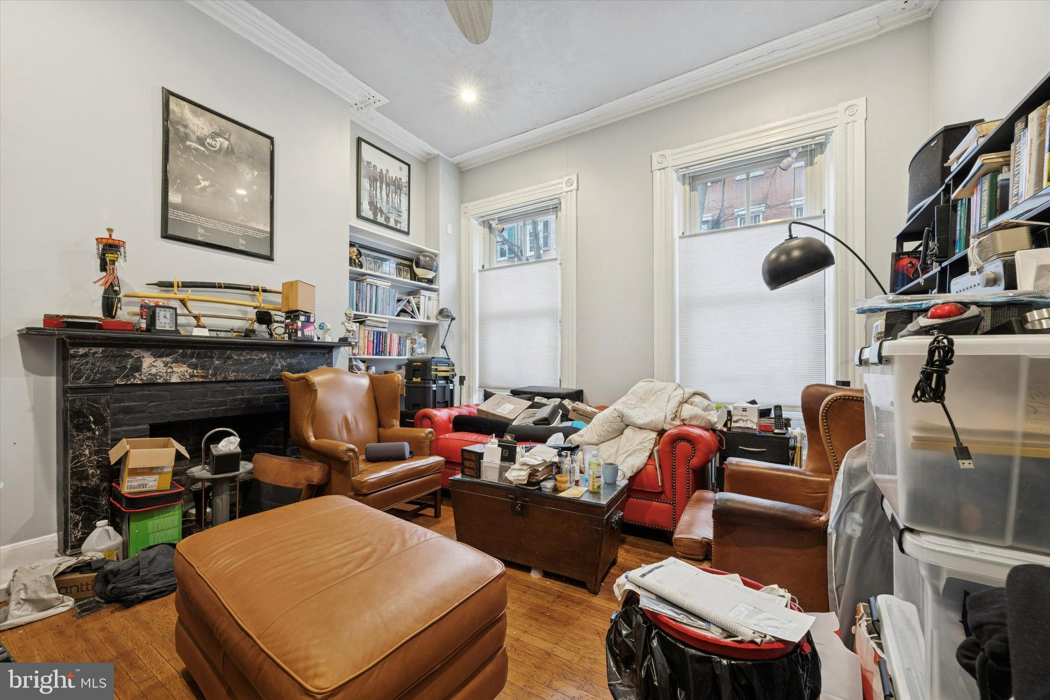 916 Clinton Street Philadelphia, PA 19107 - Photo 2 of 13 a living room with furniture a flat screen tv and a fireplace