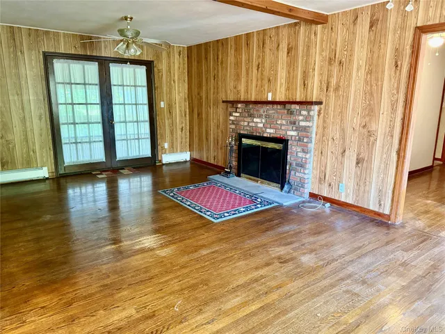 a living room with a fireplace furniture and a window