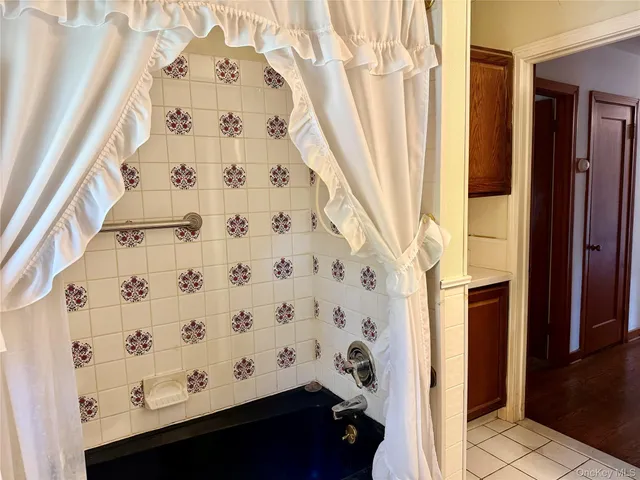 a view of an empty room with a fireplace and a window