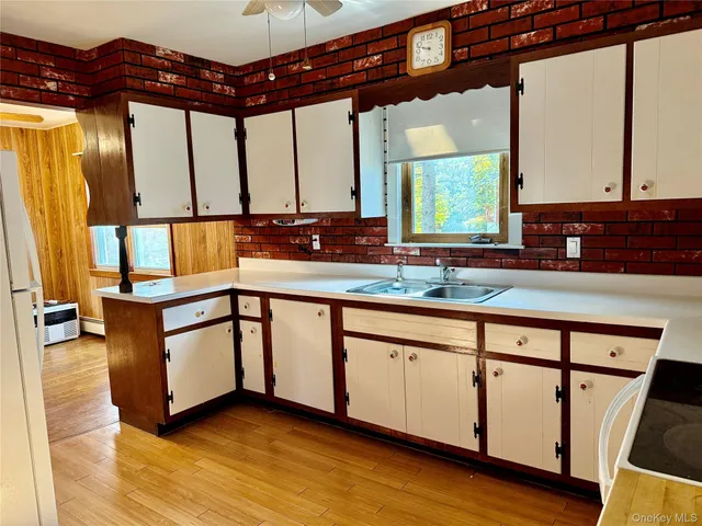 a kitchen with stainless steel appliances granite countertop a sink and a wooden cabinets
