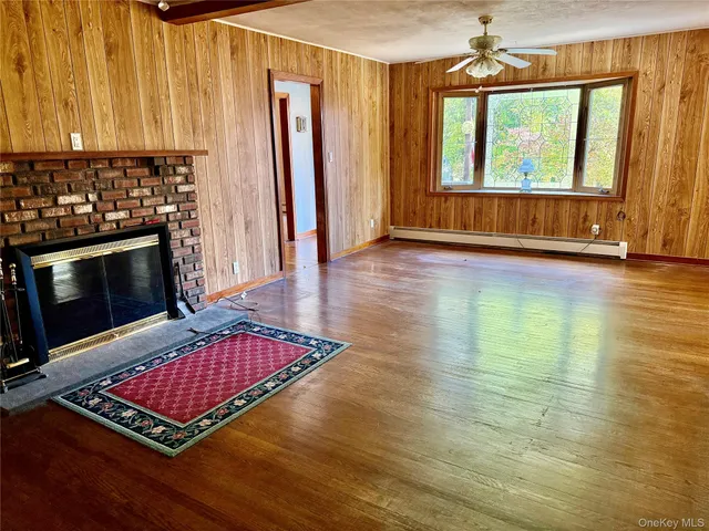 a living room with a fireplace furniture and a window