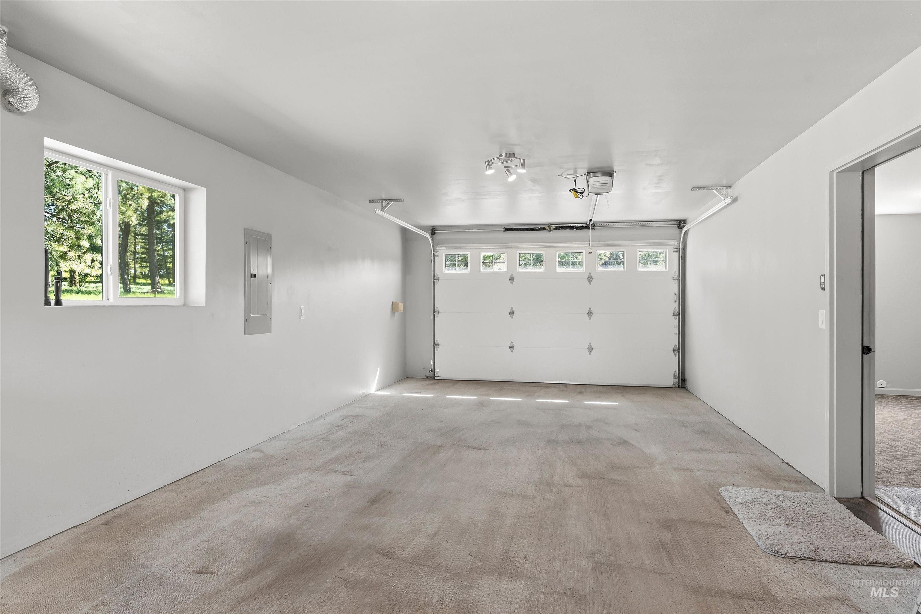 507 Bearlea Road Anatone, WA 99401 - Photo 21 of 47 Spacious garage featuring a concrete floor, overhead lighting, and a window for natural illumination