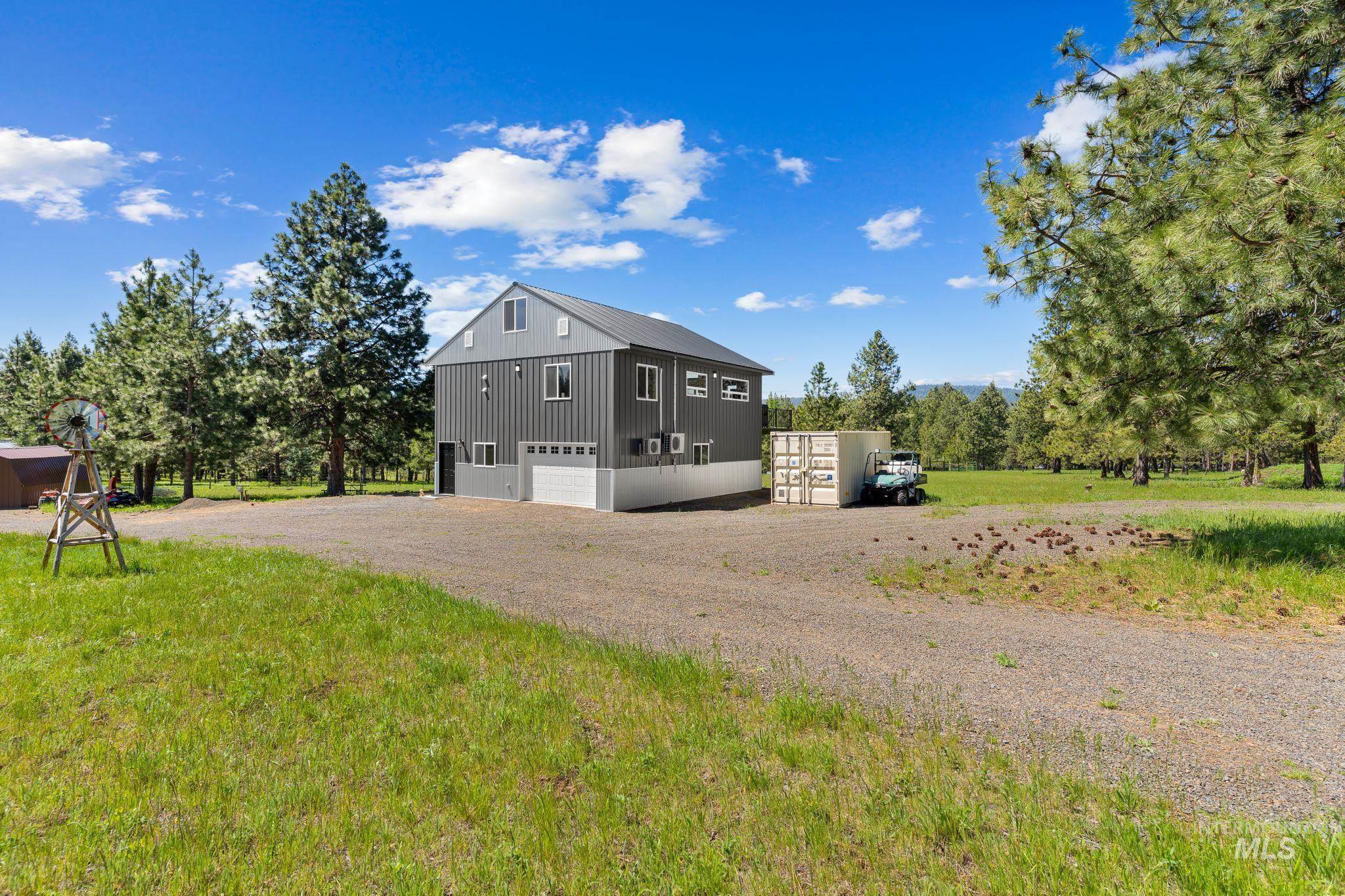 507 Bearlea Road Anatone, WA 99401 - Photo 30 of 47 Modern gray metal siding building with a white garage door