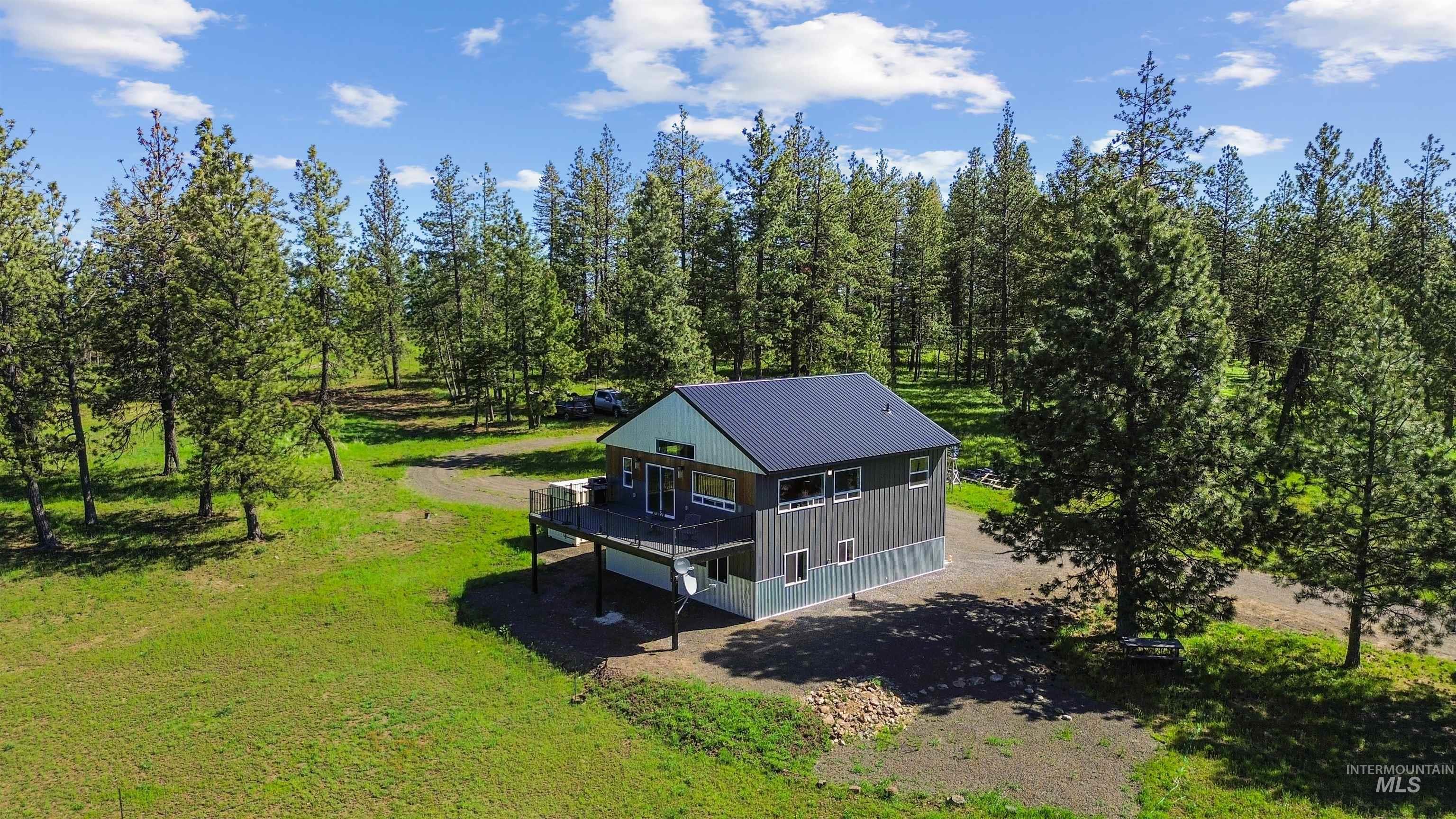 507 Bearlea Road Anatone, WA 99401 - Photo 3 of 47 Modern two-story residence featuring a dark metal roof and light green siding