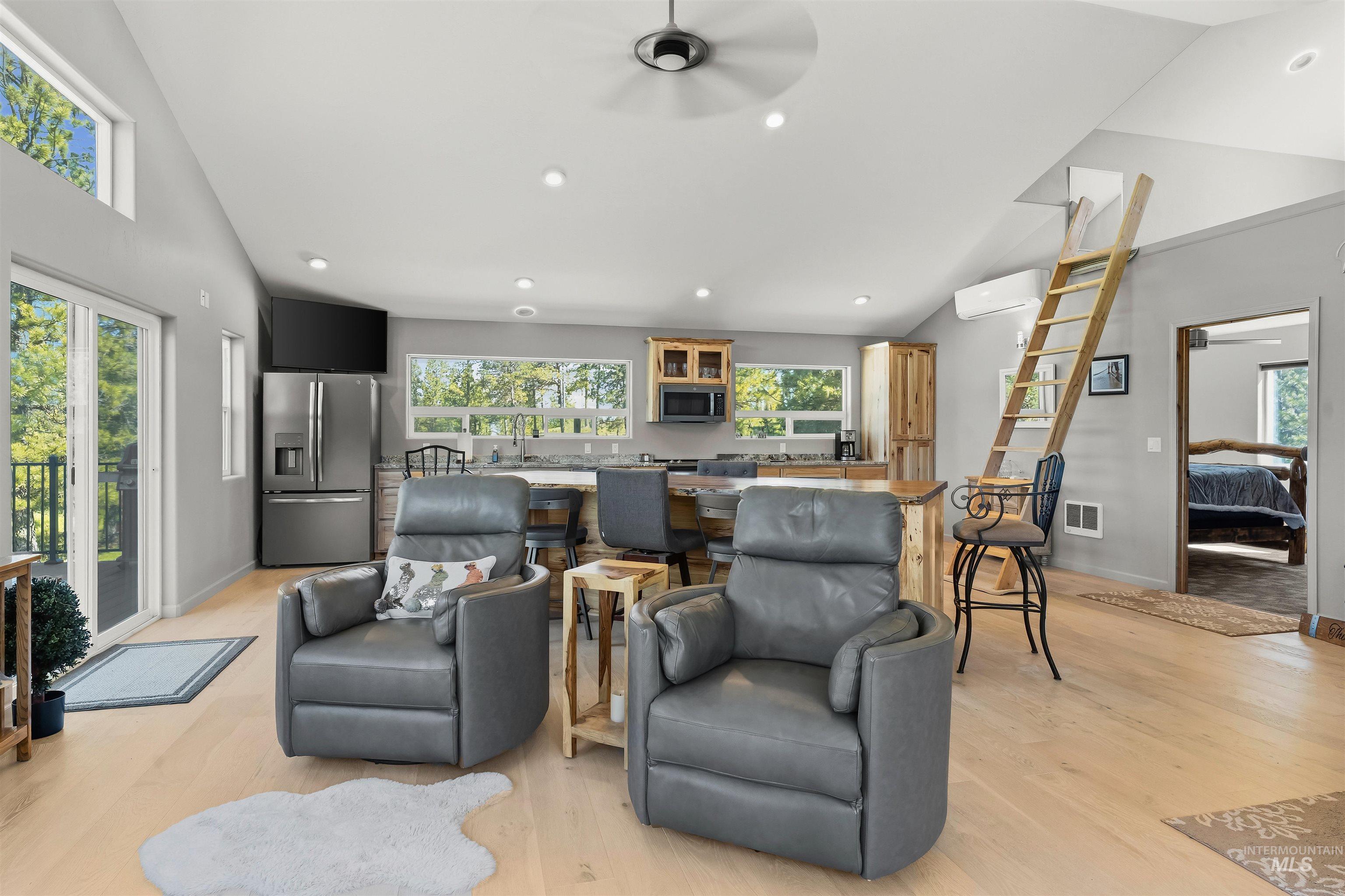 507 Bearlea Road Anatone, WA 99401 - Photo 6 of 47 Open-concept living space featuring wood-finish flooring, recessed lighting, and a vaulted ceiling with a ceiling fan