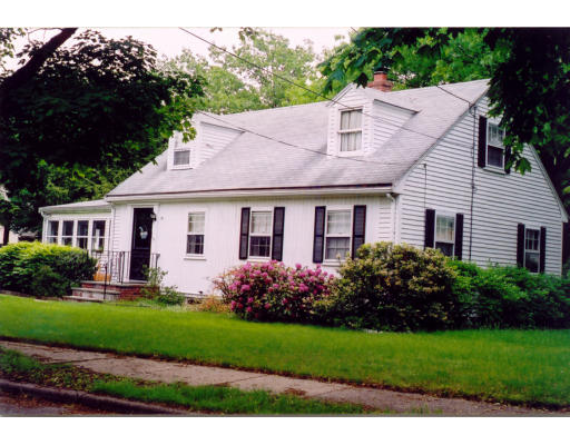 64 Truman Road Newton, MA 02459 - Photo 1 of 1 a front view of a house with a garden and plants