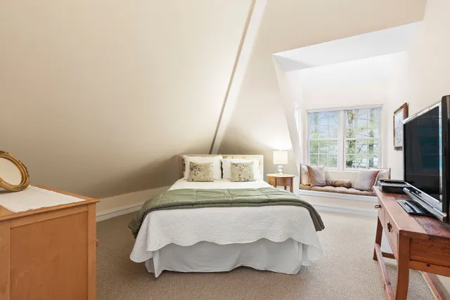 a bedroom with a bed and flat screen tv